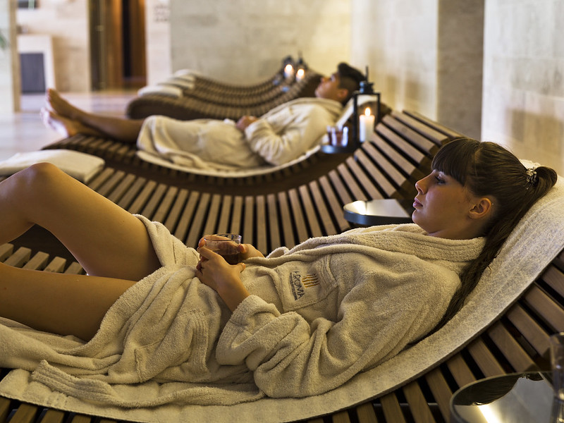 woman and man laying in chaise in a luxury spa crafted by cost-efficiency